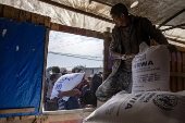 UNRWA agency hands out bags of flour to Palestinians in Khan Younis