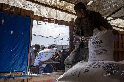 UNRWA agency hands out bags of flour to Palestinians in Khan Younis