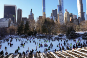 People ice skate at the Wollman Rink in Central Park, in New York