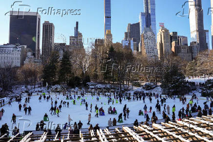 People ice skate at the Wollman Rink in Central Park, in New York