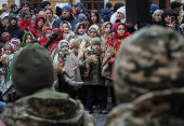 People dressed in traditional Ukrainian costumes attend a Christmas celebration in Lviv