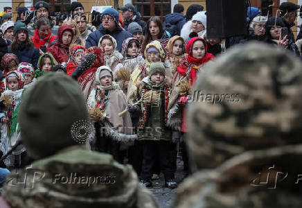 People dressed in traditional Ukrainian costumes attend a Christmas celebration in Lviv