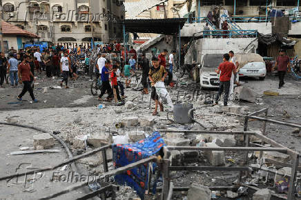 Palestinians gather at a UN school sheltering displaced people, following an Israeli strike, amid Israel-Hamas conflict, in Gaza City