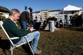 Members of the media gather outside the Gemelli Hospital where Pope Francis is admitted to continue treatment for ongoing bronchitis, in Rome