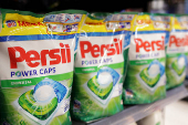 Persil products are displayed on a shelf in a supermarket