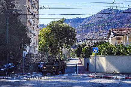 Israeli military vehicle drives in Kiryat Shmona