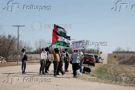 Protesters hold flags and signs as Canada?s Prime Minister Justin Trudeau visits the Waneskuwin Heritage Park