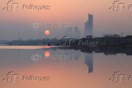 View of the sun rising amid smog and air pollution on a morning in Karachi