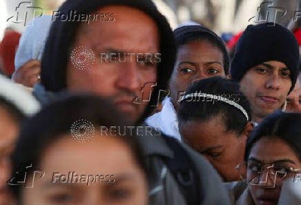 Migrants gather at El Chaparral border crossing after their CBP One app asylum appointment was cancelled on the day of U.S. President Donald Trump's inauguration, in Tijuana