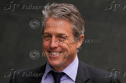 FILE PHOTO: Hugh Grant walks outside the High Court, in London