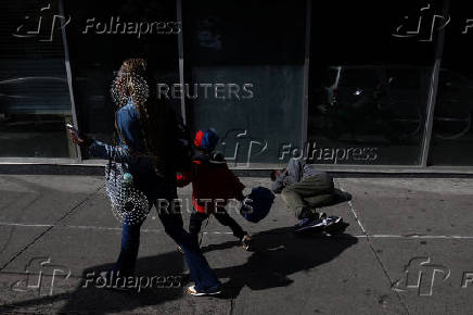 Man on sidewalk near OnPoint NYC in Harlem, New York City