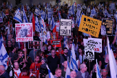 People attend a protest against Israeli Prime Minister Benjamin Netanyahu's government in Tel Aviv