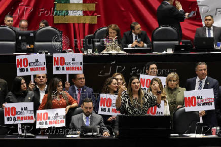 Congress members oppose a reform during a session, in Mexico City