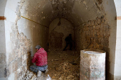 Men restore wall at Old City of Aleppo