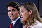 FILE PHOTO: Canada's PM Trudeau listens to Foreign Minister Freeland during news conference in Ottawa