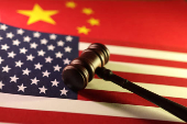 Illustration shows U.S. and Chinese flags and gavel