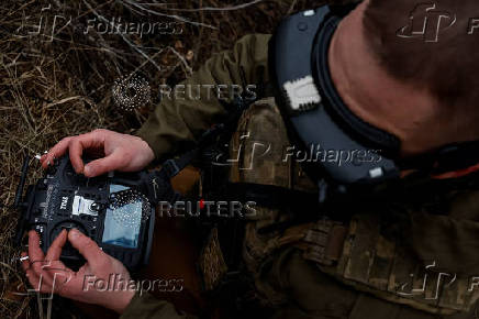 Ukrainian serviceman practice with an FPV drone, in Kharkiv region