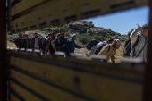 Asylum seeking migrants line up to enter the United States from Tecate, Mexico