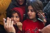 Palestinians receive aid following a ceasefire between Israel and Hamas, in Khan Younis in the southern Gaza Strip