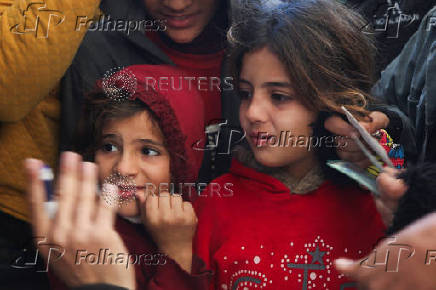 Palestinians receive aid following a ceasefire between Israel and Hamas, in Khan Younis in the southern Gaza Strip