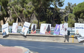 Campaign posters of candidates running in the country's parliamentary election are placed on a road in Amman