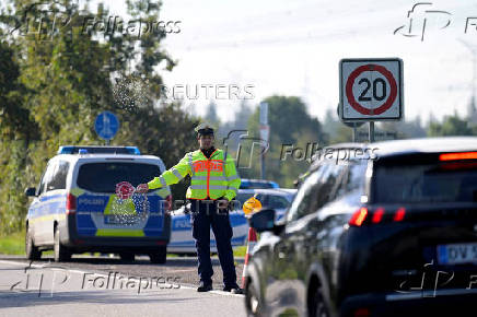 FILE PHOTO: German police conduct random checks at a border with Denmark, in Boeglum