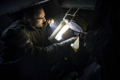 Servicemen prepare a howitzer to fire towards Russian troops at a frontline near the town of Chasiv Yar