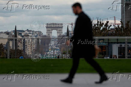 FILE PHOTO: People walk on the esplanade of La Defense
