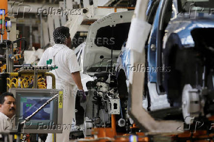 FILE PHOTO: An employee works on the production line of the Volkswagen Tiguan cars at the company's assembly plant in Puebla,