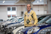 The founder of Gruppo Fassina, Tony Fassina poses for pictures in the showroom of his car dealership in Milan, Italy