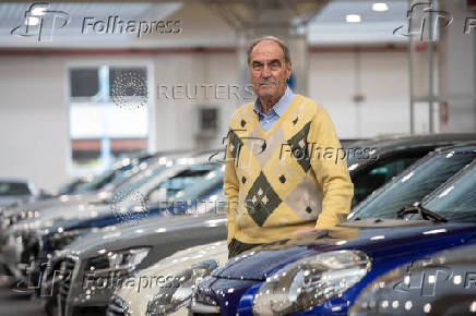 The founder of Gruppo Fassina, Tony Fassina poses for pictures in the showroom of his car dealership in Milan, Italy