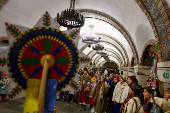 People dressed in traditional clothes sing carols inside a metro in Kyiv