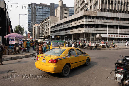 A taxi cab drives through Broad Street in Lagos