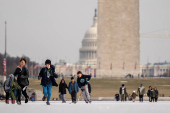 People skate on the ice-covered Lincoln Memorial Reflecting Pool on the National Mall, in Washington