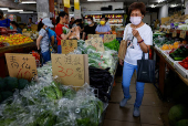 People shop for fruits and vegetables at a market in Taipei