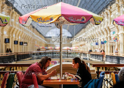 People lunch in a cafe in GUM department store in Moscow