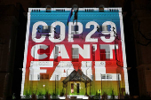 FILE PHOTO: Climate activists project a message onto the Embassy of Azerbaijan ahead of COP29 climate talks, in London