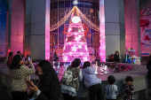 People take photos of a Christmas tree in New Taipei City