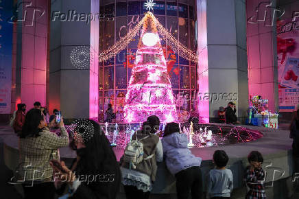 People take photos of a Christmas tree in New Taipei City