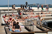 People relax on Melbourne St Kilda beach