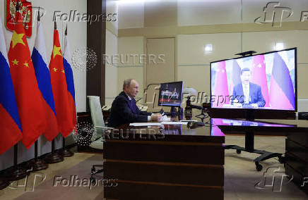 Russian President Vladimir Putin holds a video conference meeting with Chinese President Xi Jinping, outside Moscow