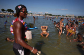 People cool off at the artificial pond known as Piscinao de Ramos in Rio de Janeiro