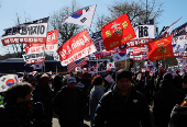 Impeached South Korean President Yoon Suk Yeol's supporters rally near the Corruption Investigation Office for High-ranking Officials, following his arrest, in Gwacheon