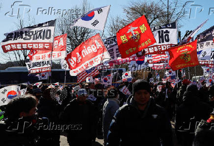 Impeached South Korean President Yoon Suk Yeol's supporters rally near the Corruption Investigation Office for High-ranking Officials, following his arrest, in Gwacheon