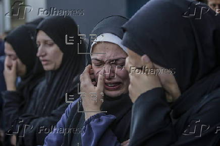 Palestinians mourn their dead at Deir Al Balah hospital after Israeli airstrike in central Gaza