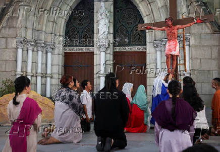 Youth perform a re-enactment of the crucifixion of Jesus Christ during Good Friday at Jakarta Cathedral