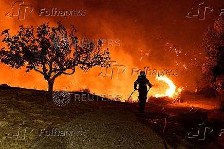 Wildfire burns next to the village of Kallithea, near Corinth