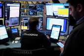 Traders work on the floor of the NYSE in New York