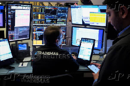 Traders work on the floor of the NYSE in New York