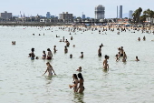 Beachgoers enjoy St Kilda beach